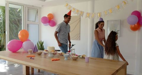 Family Celebrating Birthday at Home with Smiles and Joy