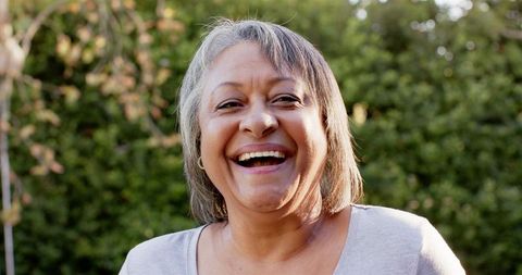 Joyful Senior Woman Laughing Outdoors, enjoying Leisure