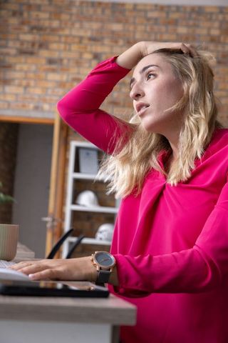 Creative woman working in modern design studio with laptop