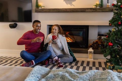Diverse Couple Enjoying Cozy Christmas by Fireplace