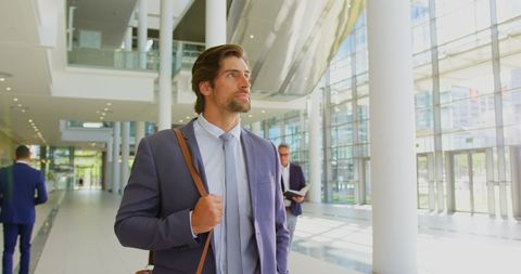 Confident Businessman Walking Through Modern Office Lobby - Download Free Stock Images Pikwizard.com