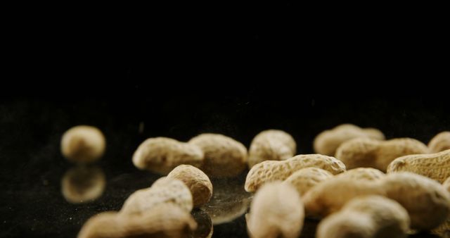 Close-Up of Peanuts on Reflective Surface with Black Background - Download Free Stock Images Pikwizard.com