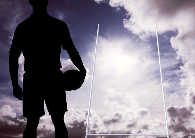 Digital composition of silhouette of player holding a ball near goal against sky background