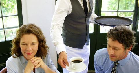 Business Professionals Being Served Coffee in Restaurant
