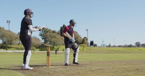 Cricket Training: Batsman and Wicketkeeper in Practice at Park