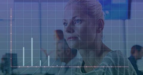 Woman Examining Intersecting Charts with Digital Overlay