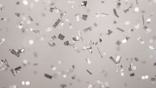 Silver Confetti Falling with Sparkling Bokeh on Soft Neutral Background