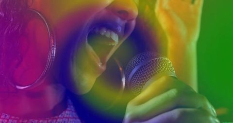 Dynamic female singer performing on stage with vibrant aura