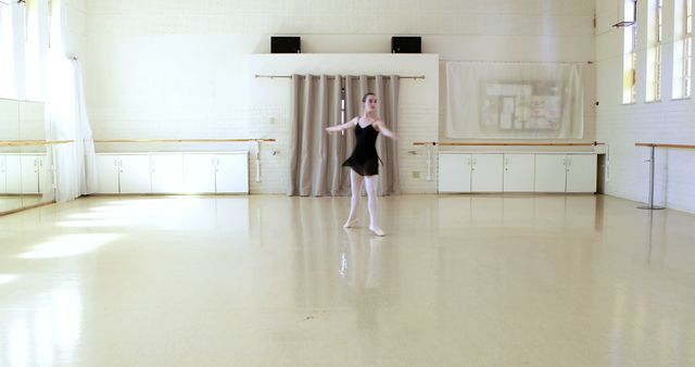 Ballerina is dancing in a dance hall 