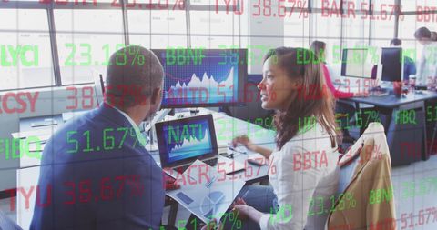 Diverse Team Analyzing Stock Market Trends in Office Environment