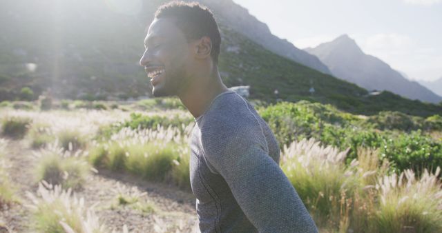 Smiling Man Enjoying Outdoor Run in Scenic Mountain Landscape - Download Free Stock Images Pikwizard.com