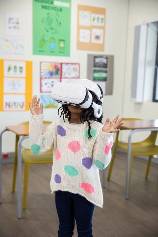 Child Engaging with VR Technology in School Classroom