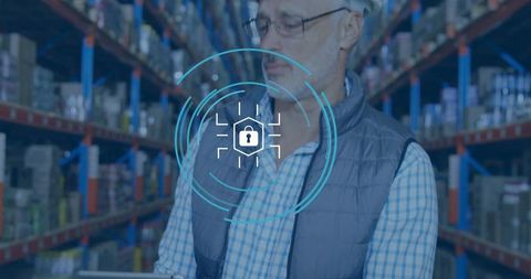 Warehouse supervisor inspecting inventory with tablet showing digital security overlay