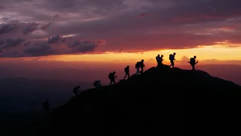 Group of Hikers Cycling Crests Under Vibrant Sunset