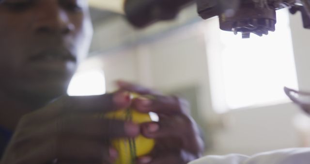 African American Technician Adjusting Robotic Arm Holding Sphere - Download Free Stock Images Pikwizard.com