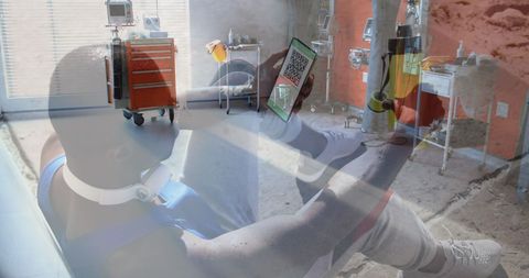 man holding smartphone with qr code against hospital environment - Download Free Stock Images Pikwizard.com