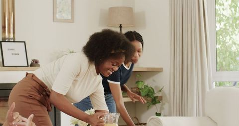 Happy Friends Sharing Beverages in Cozy Home Environment
