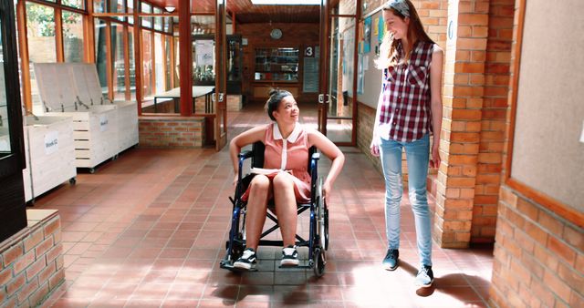 Teen Girl in Wheelchair Interacting with Friend Indoors - Download Free Stock Images Pikwizard.com