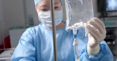 Medical professional adjusting iv fluids in healthcare setting