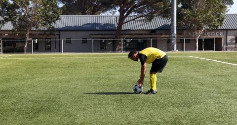 Soccer Player Preparing Free Kick on Sunny Day