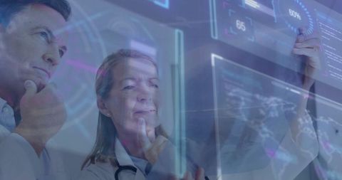 Doctors Analyzing Data on Digital Screen in Futuristic Lab Setting