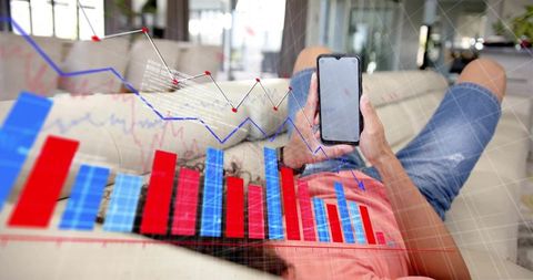 Man reclining on sofa analyzing financial charts on smartphone with bar and line graphs overlay