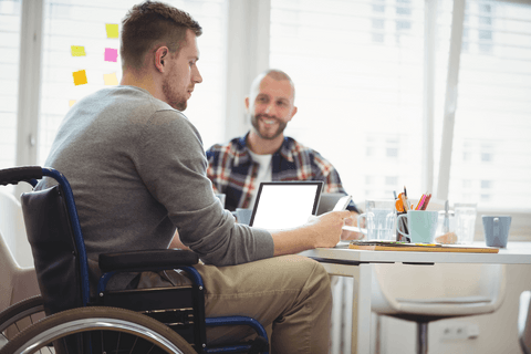 Focused Man in Wheelchair Using Tablet in Modern Work Environment Transparent - Download Free Stock Videos Pikwizard.com