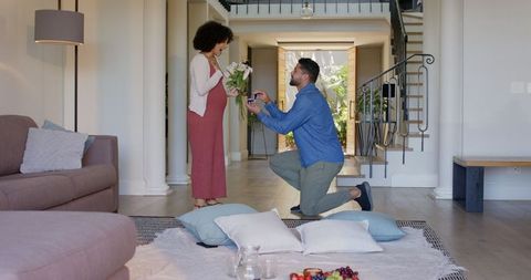 Man Proposing to Woman Indoors with Ring Box