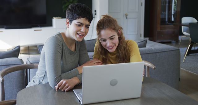 Young Women Smiling While Looking at Laptop at Home - Download Free Stock Images Pikwizard.com