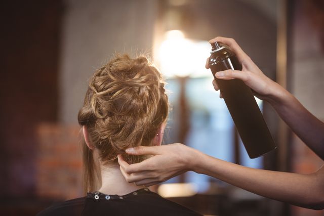 Female hairdresser styling customers hair at a salon