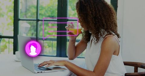Working woman typing on laptop and sipping juice at bright home workspace with magenta overlays
