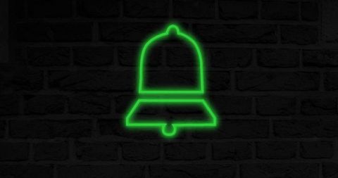Neon Green Bell Icon on Dark Brick Wall Symbolizing Notifications