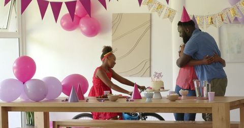 Happy Family Birthday Celebration with Decorations and Hugs at Home