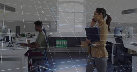 Businesswoman in Open Plan Office Using Communication Technology