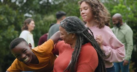 Diverse Family Bonding Outdoors with Laughter and Joy