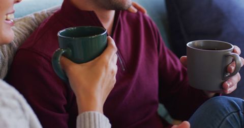 Couple Enjoying Coffee on Cozy Sofa at Home