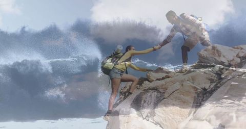 Hiking Friends Helping Each Other on Coastal Cliff Adventure