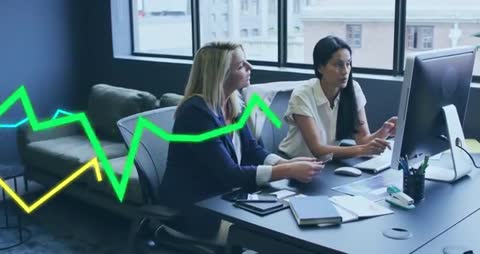 Business Meeting with Rising Data Trends Overlaid on Monitor