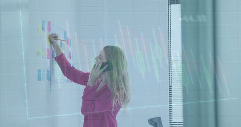 Businesswoman Planning Strategy with Digital Graph Overlay