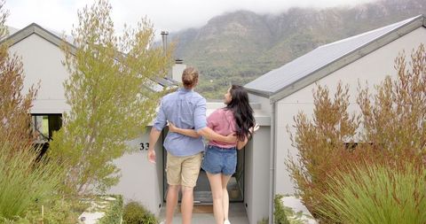 Happy Couple Embracing New Home with Stunning Mountain View