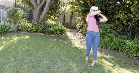 Woman Experiencing Virtual Reality in Outdoor Setting