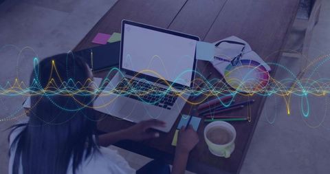 Working woman using laptop and smartphone with vr headset and colorful sticky notes