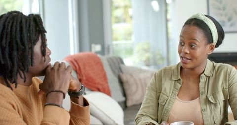 African American Couple Having Heartfelt Conversation on Cozy Living Room Sofa