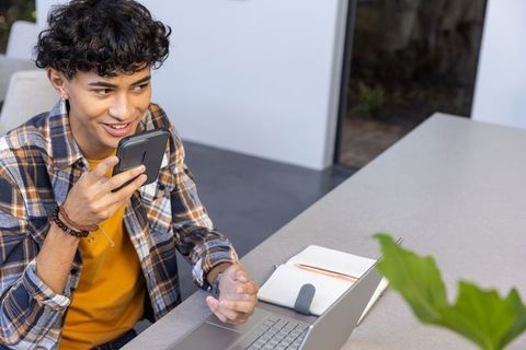Young adult engaged in voice conversation at modern workspace