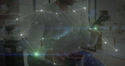 man using smartphone and drinking coffee in modern room - Download Free Stock Images Pikwizard.com