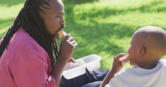 Father and Son Enjoying Picnic Together in Sunny Park - Download Free Stock Images Pikwizard.com