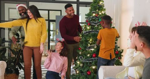 Diverse Family Celebrating Christmas Decorating Tree Together