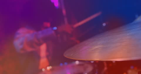 Vibrant Light Effects with Drummer Creating Music on Stage