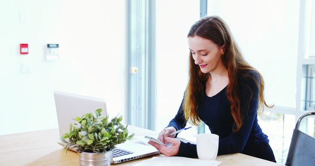 Young Woman Working at Home on Laptop and Smartphone - Download Free Stock Images Pikwizard.com