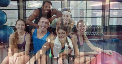 Smiling fitness group showing teamwork and energy in gym with workout balls and dumbbells